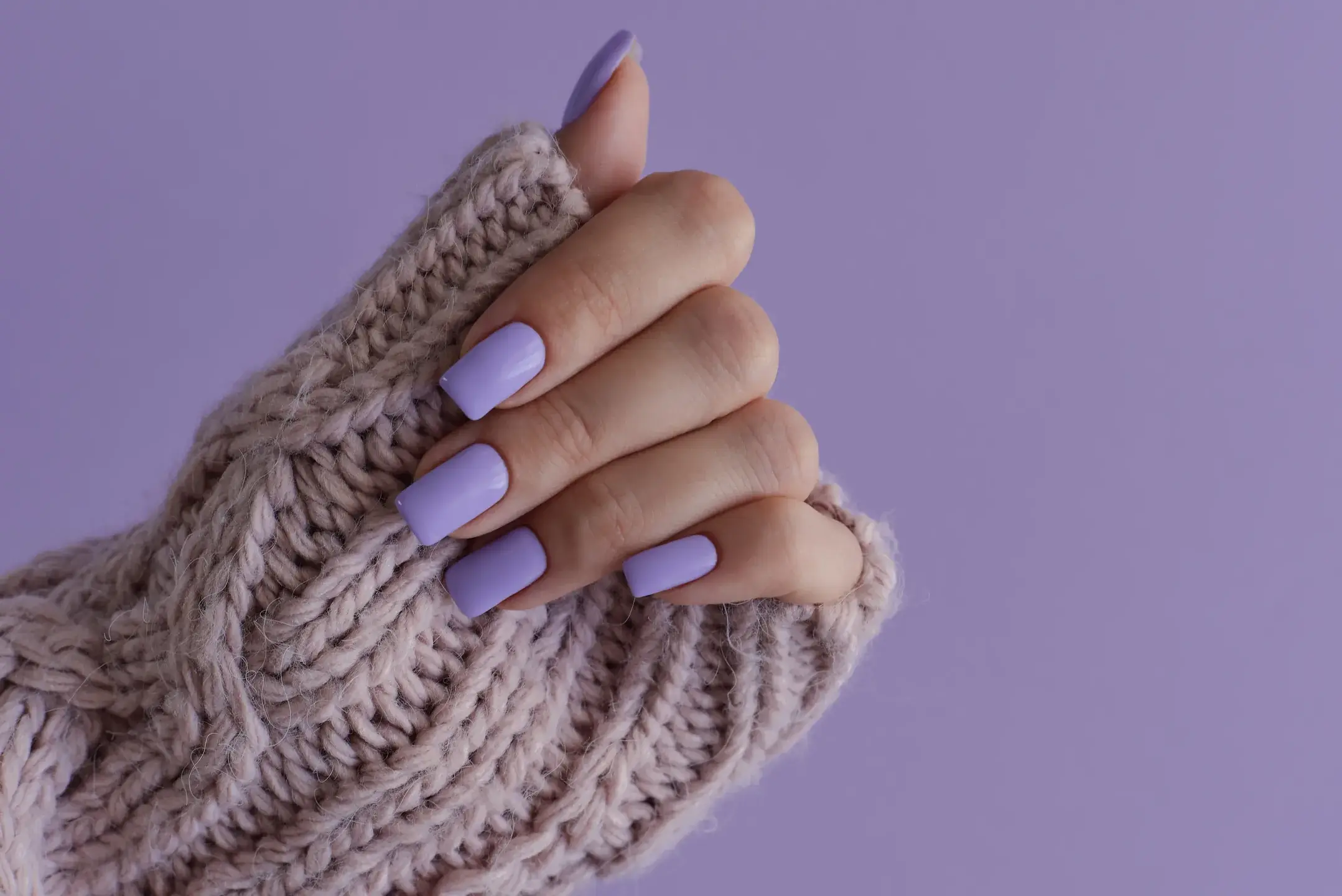 Elegant hand with purple manicure and knitted slee 2026 03 09 09 19 09 utc